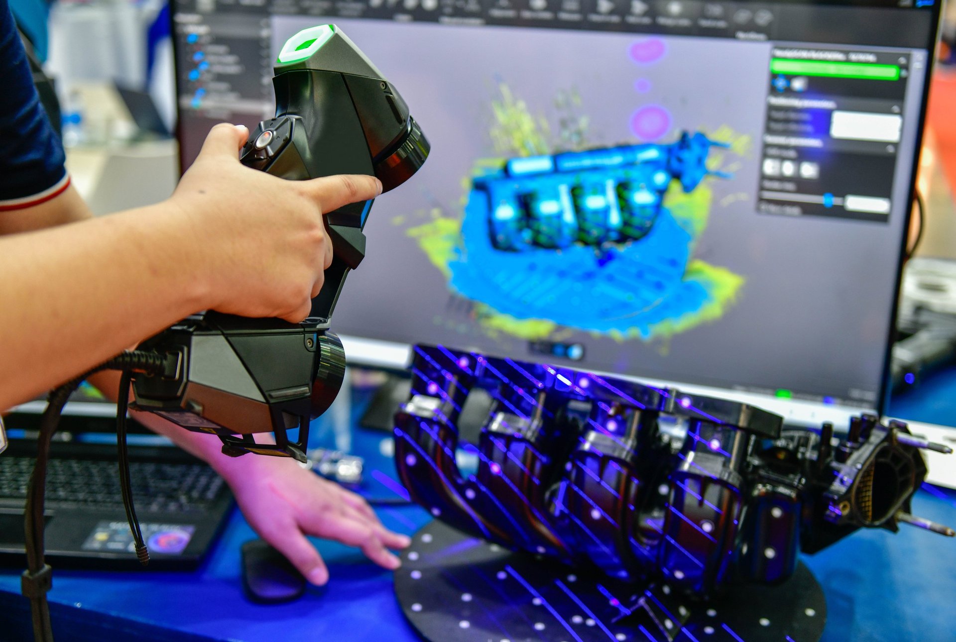 Portable 3D handheld scanner scanning a car part in automotive industry