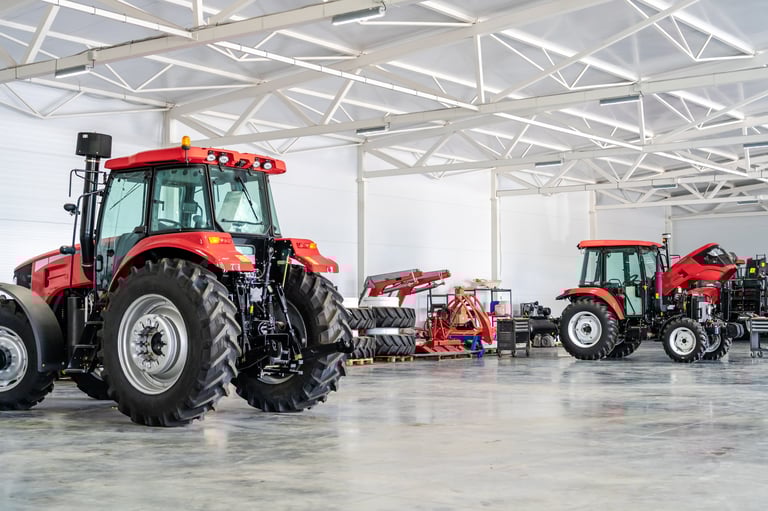 Modern tractors in industrial service workshop for agricultural machinery repair, maintenance, equipment storage, and smart farming technologies.