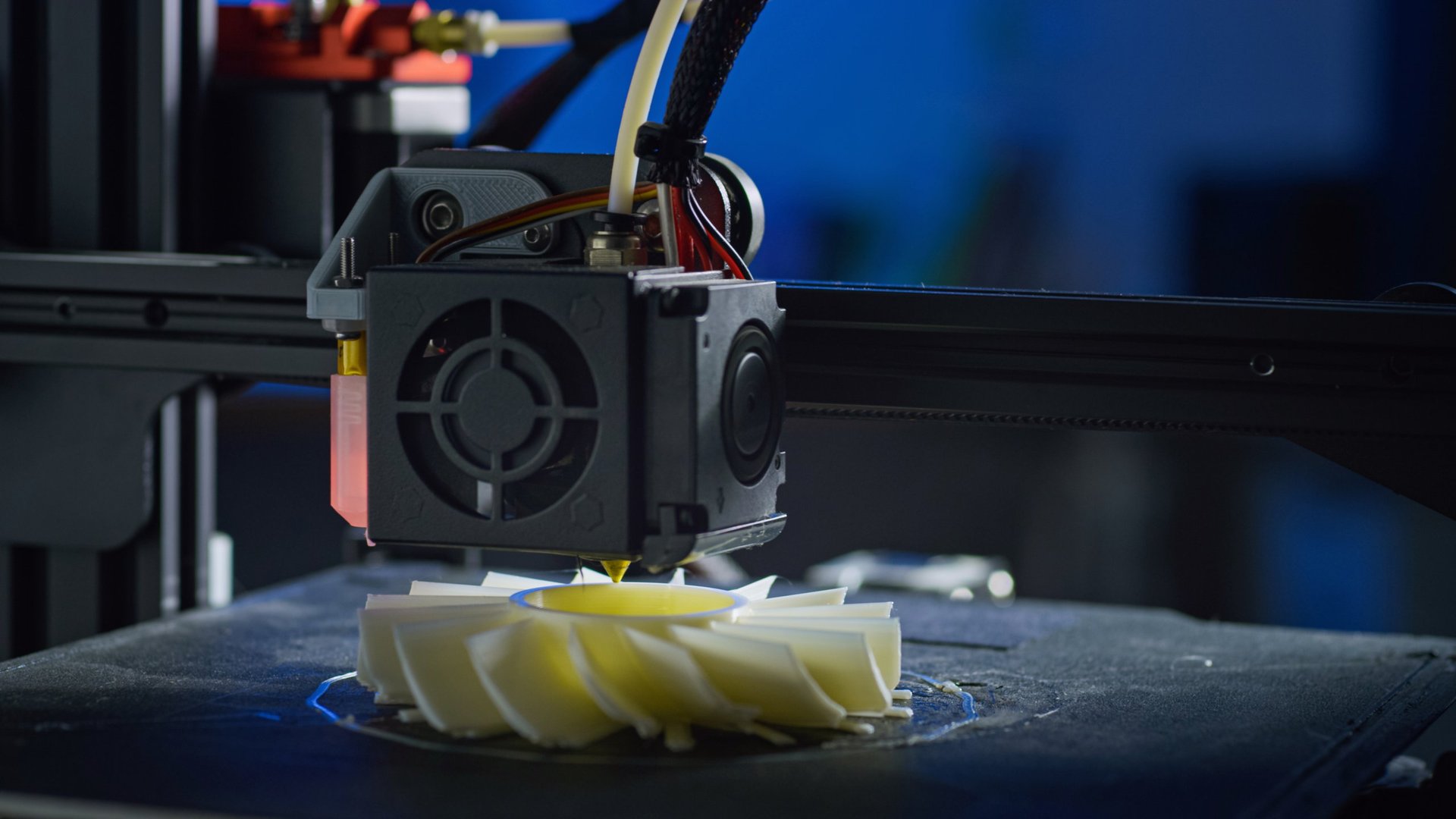 A 3D printer creates a plastic prototype using additive manufacturing in a clean workspace. This highlights automation and precision.