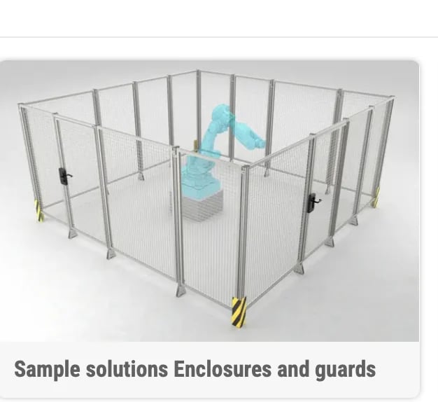 Metal frame safety enclosure with mesh panels and blue machinery inside, labeled as sample solutions enclosures and guards