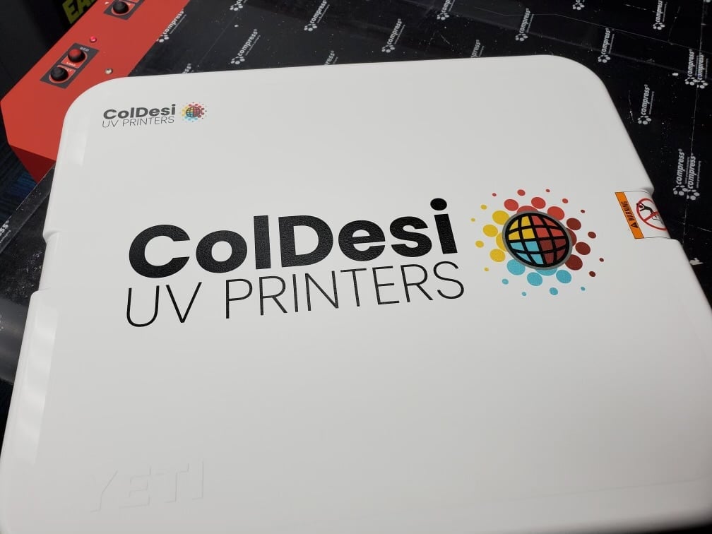ColDesi UV Printers branded material with colorful globe logo on white background
