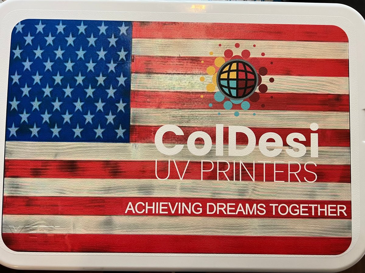 ColDesi UV Printers logo on American flag wooden background with tagline Achieving Dreams Together
