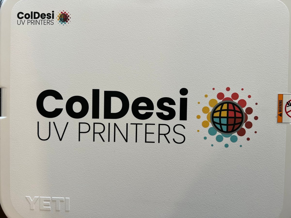 ColDesi UV Printers logo on white surface with colorful globe graphic and YETI branding